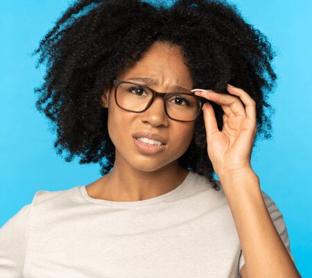 African American woman wearing glassed and frowning